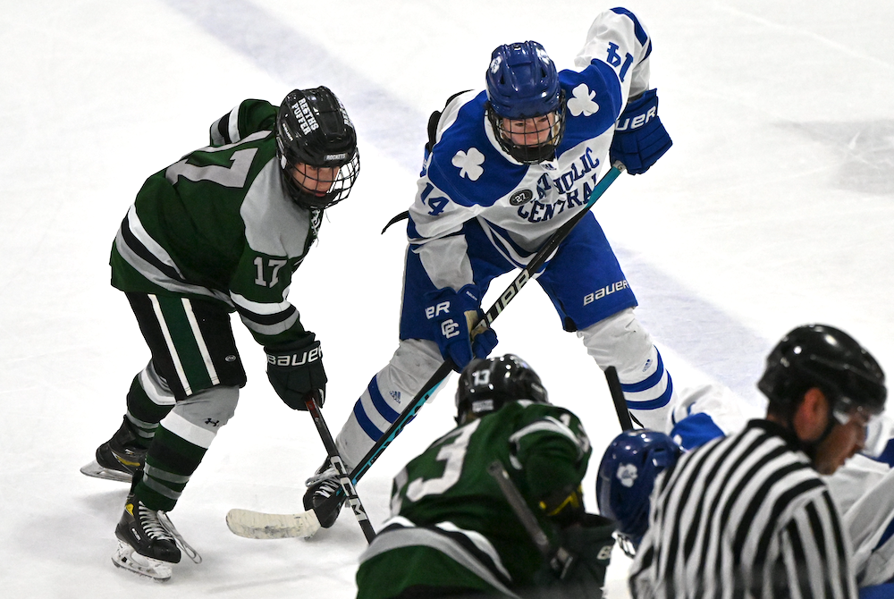 Detroit Catholic Central’s Joshua Granowicz (14) and Muskegon Reeths-Puffer’s Eli Cuti (17) await a faceoff during their Division 1 Semifinal on March 8 at USA Hockey Arena. 