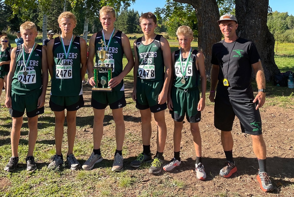 The Painesdale Jeffers boys cross country team shows off its hardware after winning its invitational at the Kilpela farm Aug. 31. 