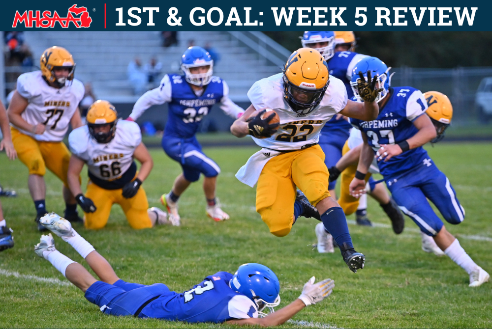 A Negaunee ball carrier leaps over an Ishpeming defender during their game on 9-23-22.