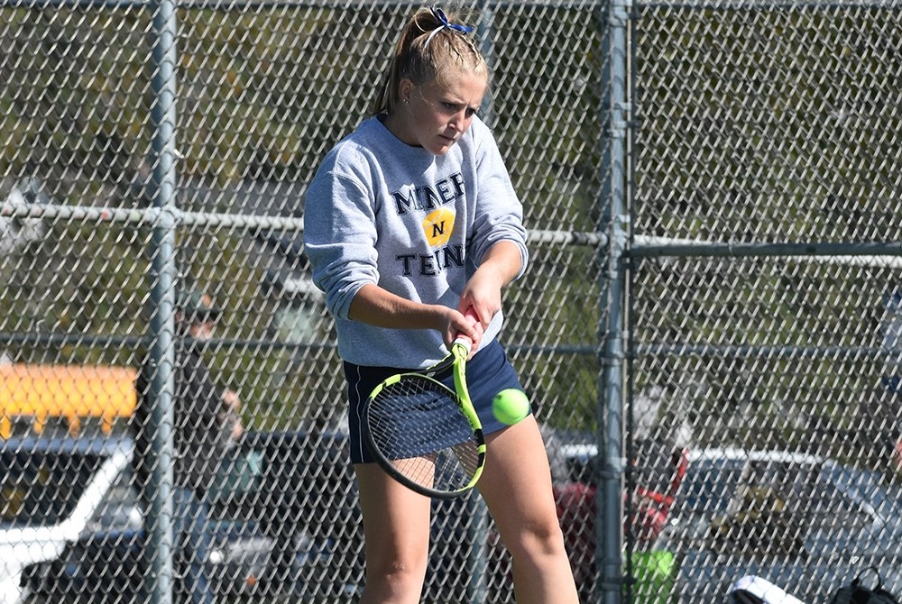 Negaunee’s Jordan Enright returns a volley during a No. 1 singles semifinal match Wednesday.