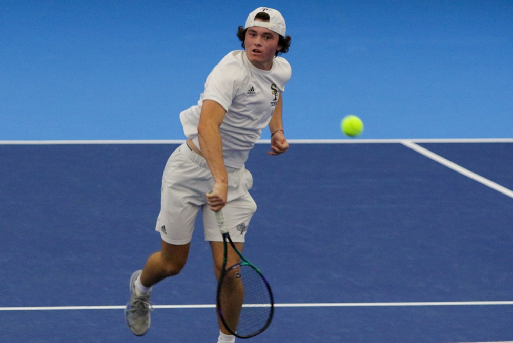 Traverse City St. Francis’ Tristan Bonanni returns a volley during a No. 2 singles match at the 2021 Lower Peninsula Division 4 Finals.