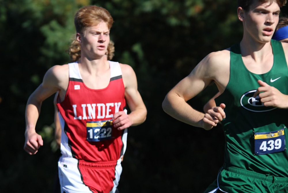 Linden’s Kyle Eberhard, left, runs with a pack during the Shepherd Blue Jay Invitational on Oct. 1. 