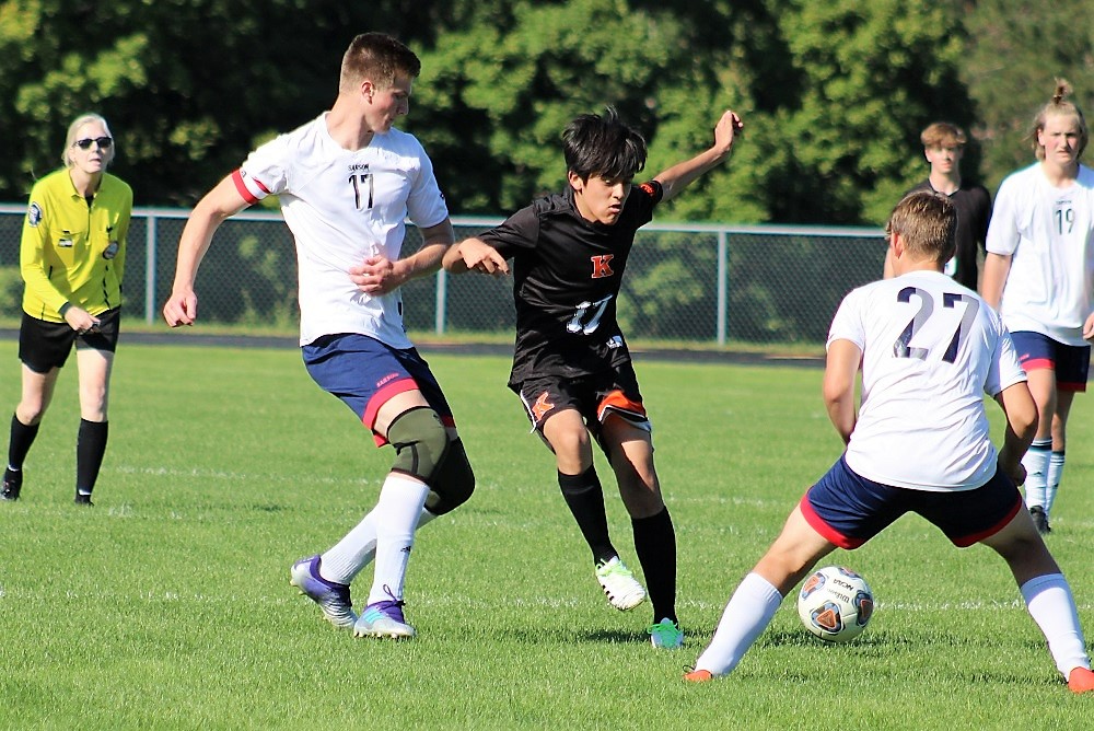 Kingsley’s Rolando Torres battles Traverse City Bulldogs’ Tyler Ritola (17), Jonathon Scott (27) and Syrus Ritola (19), as Josephine Arrowood officiates. 