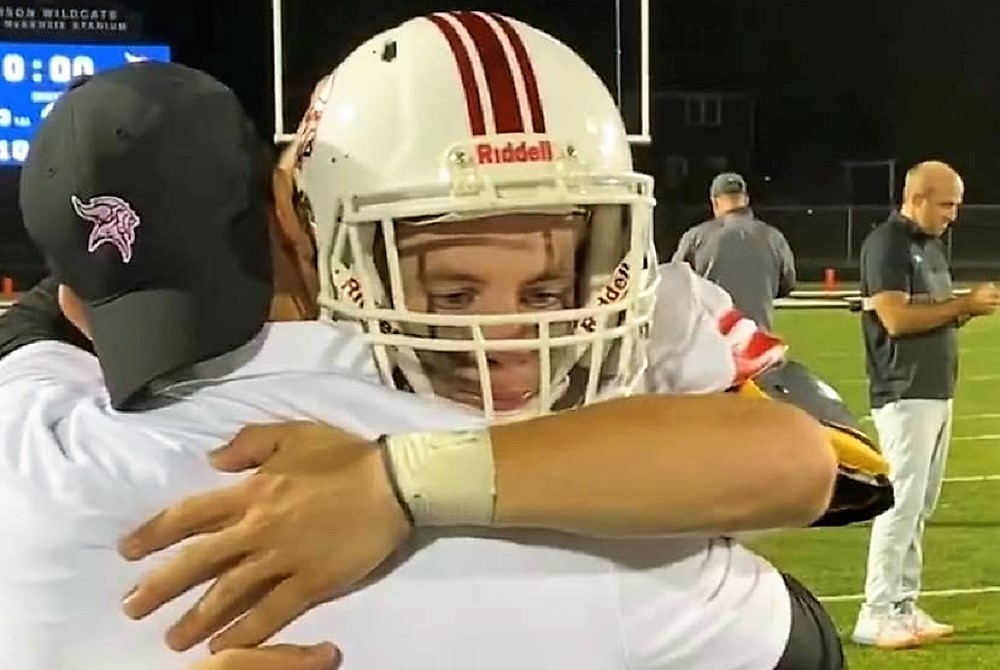 Whitehall quarterback Kyle Stratton embraces his father Keith after a game this season. 