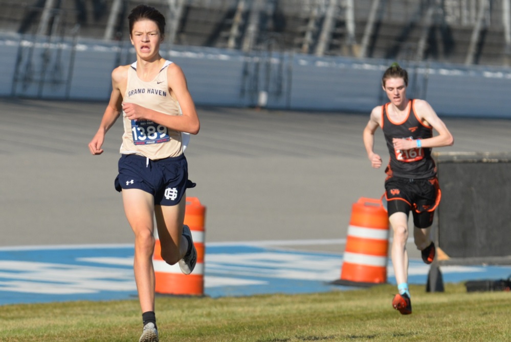 Grand Haven’s Seth Norder, left, and Grand Rapids Ottawa Hills’ Benne Jackson enter the final stretch during last season’s LPD1 Final.