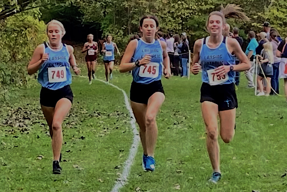 From left, Lansing Catholic’s CC Jones (749), Tessa Roe (745) and Hannah Pricco (755) lead the pack during a race. 