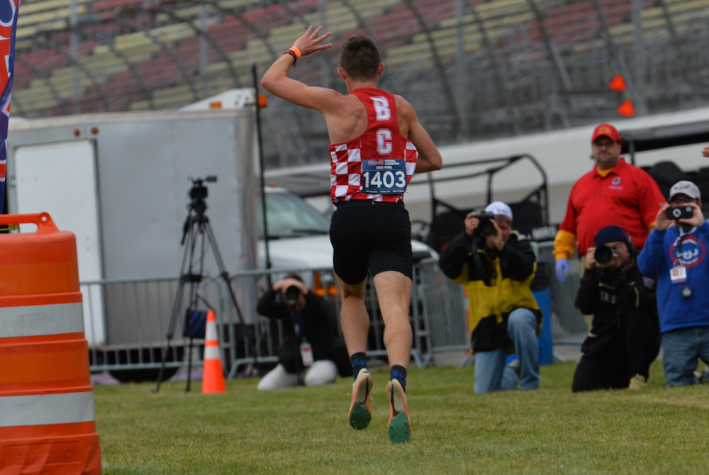 Benzie Central’s Hunter Jones throws up the customary four fingers to symbolize his four championships as he crosses the line at MIS on Saturday. 