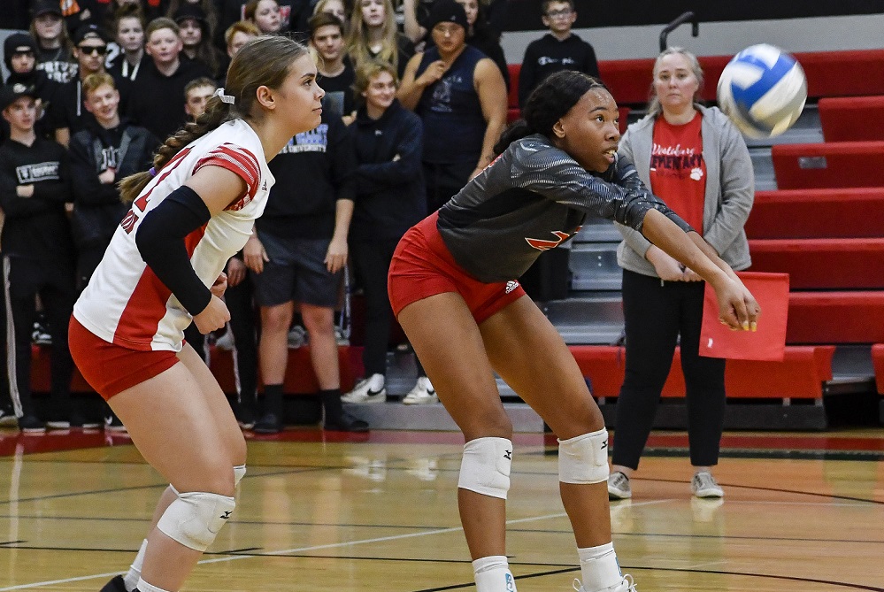 Mount Pleasant Sacred Heart’s Angel Brown (23) hits from the back row with teammate Bridget Ruiz (12) beside her during a match against Coleman.