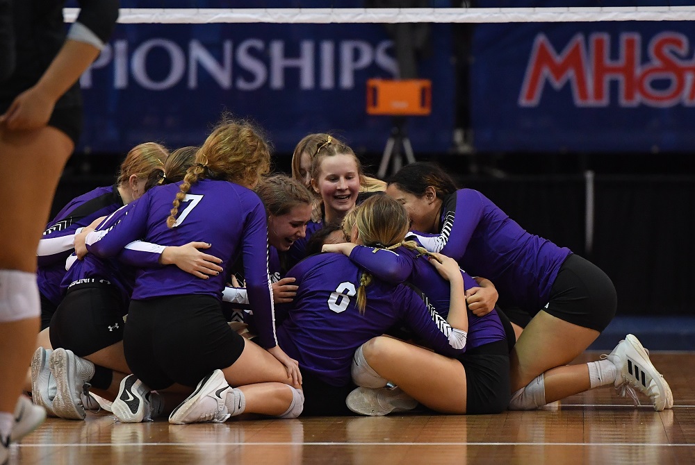 Athens players engulf each other after clinching their first trip to Finals day by sweeping Lansing Christian at Kellogg Arena. 