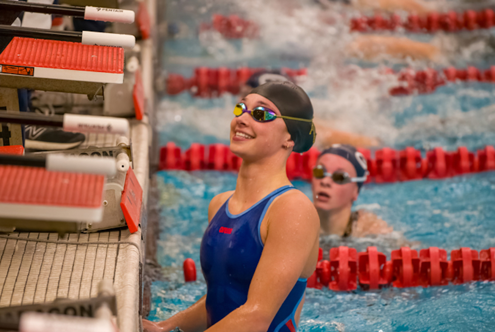 Ogemaw Heights’ Kiera Danitz pops up from the water happy after touching the wall first during one of her races at the Independent Swim Conference championship meet. 