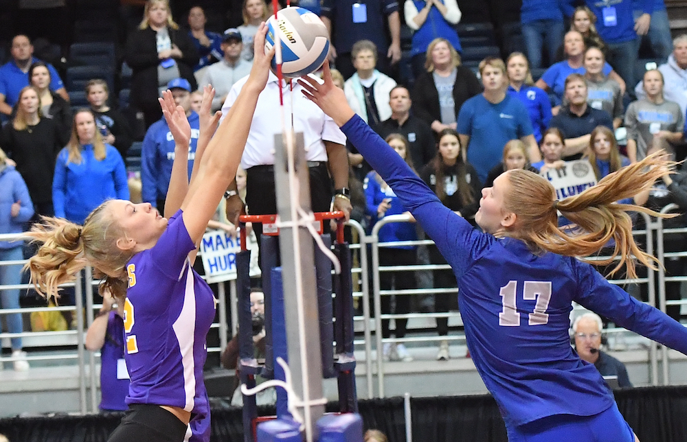 Kalamazoo Christian’s Annelise de Jong (2) and Calumet’s Allison Bjorn (17) simultaneously make contact with the ball at the net during their Division 3 Semifinal on Friday,