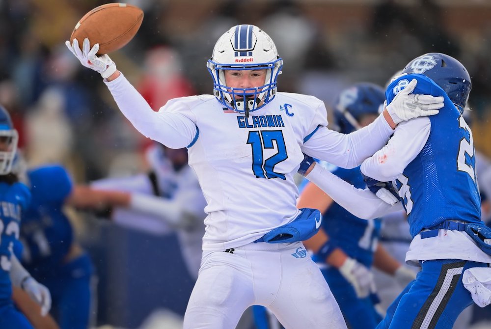 Gladwin's Logan Kokotovich (12) holds onto the ball during Saturday's Semifinal win over Grand Rapids Catholic Central.