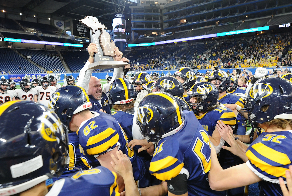 Whiteford coach Todd Thieken presents the Division 8 championship trophy to his team Saturday at Ford Field. 