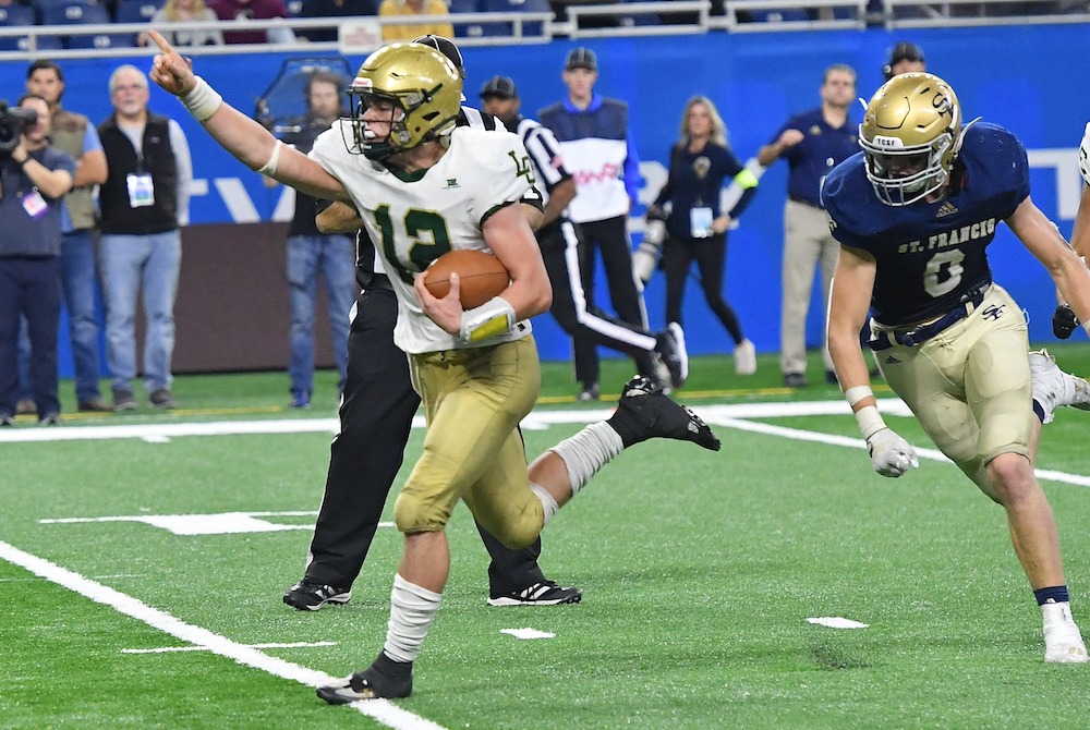 Lumen Christi quarterback Joe Lathers (12) charges toward the end zone during the fourth quarter of Saturday’s Division 7 Final. 