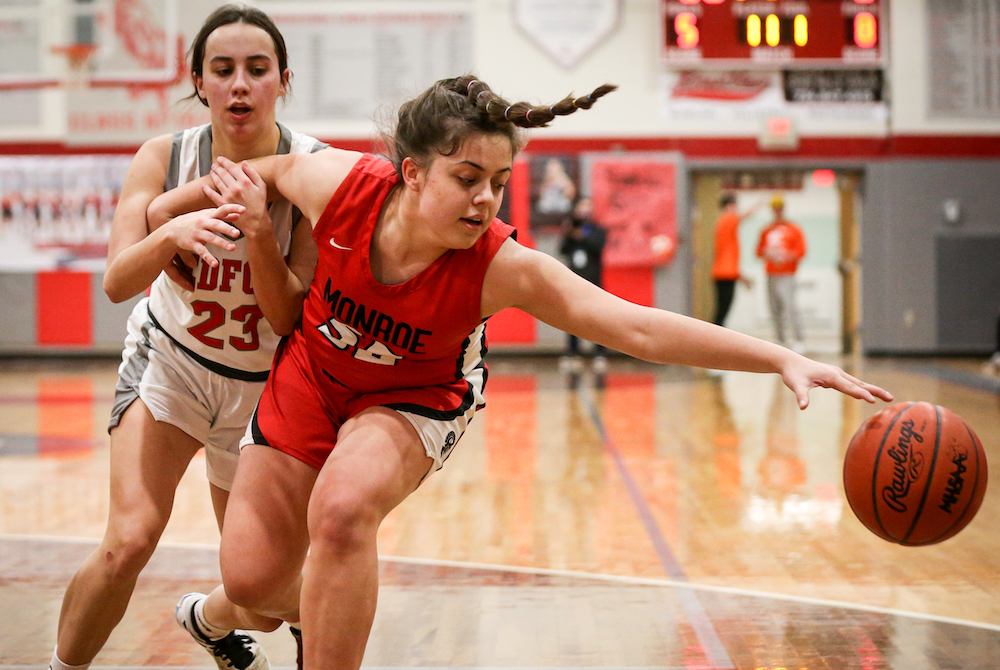 Monroe’s Sophia Bussell reaches for a loose ball last season against Temperance Bedford.