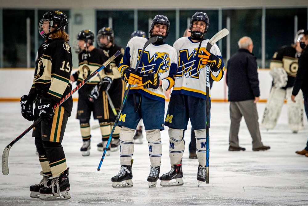 Twins Zach (left) and Kaleb Kruzich take a moment for a photo during a Mattawan game night. 