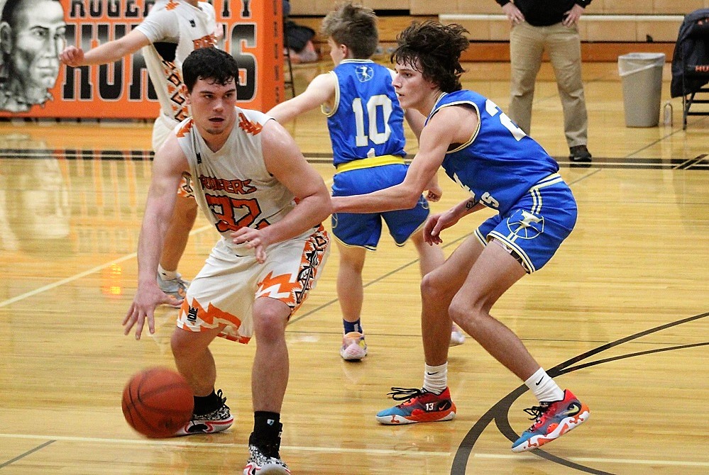 Mio’s Gage Long (24) defends during a 57-17 win over Rogers City on Tuesday.