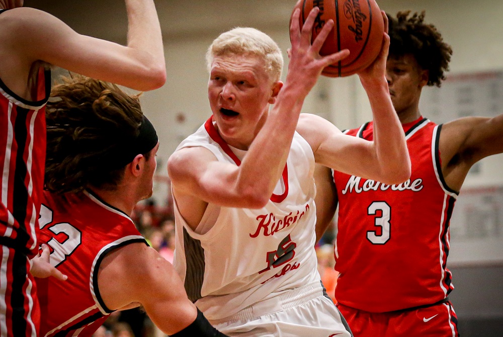 Bedford’s Andrew Hollinger works for an opening while surrounded by Monroe defenders during a 63-43 win Friday.