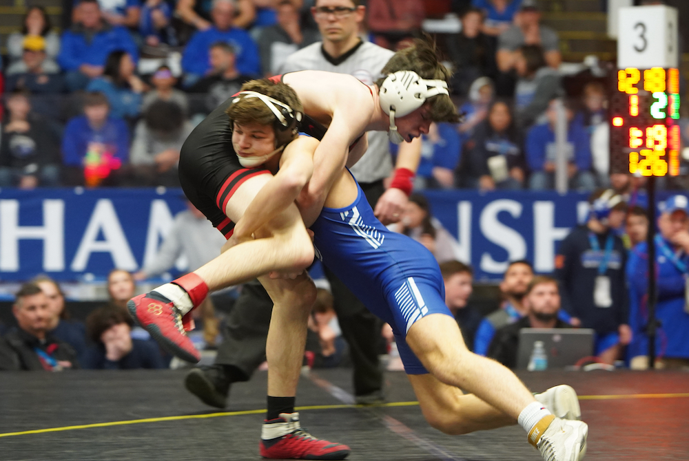 Dundee’s Kaden Chinavare, right, goes for a takedown during his 126-pound match with Whitehall’s Caden Varela. 