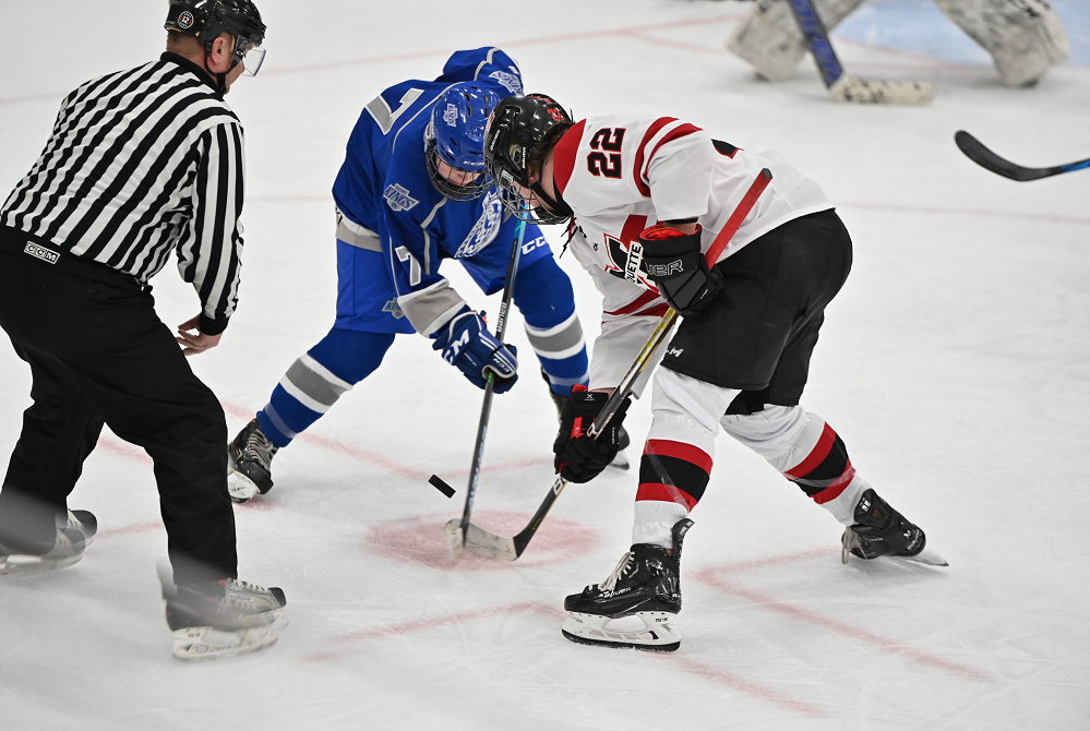 Calumet's Erik Loukus (7) and Marquette's Rylan Ragusett (22) face off in the second period of a game this season.
