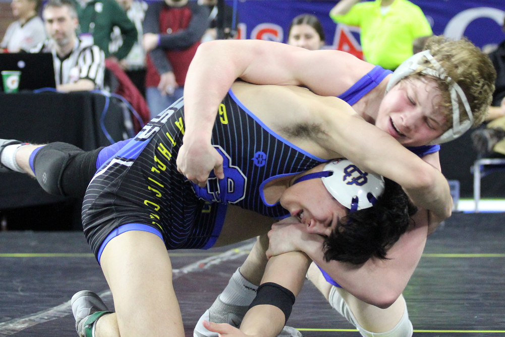 Dundee's Braeden Davis wrestles Grand Rapids Catholic Central's Michael Wilson for the 138-pound championship in Division 3 this season.