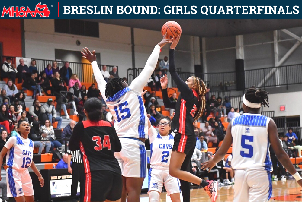 Carman-Ainsworth’s Armoni Strozier (15) gets a hand on a shot during a District win over Flushing.