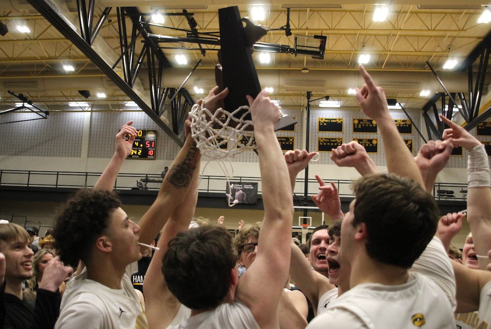 Hamilton raises its first boys basketball District championship trophy since 1987 on March 10.