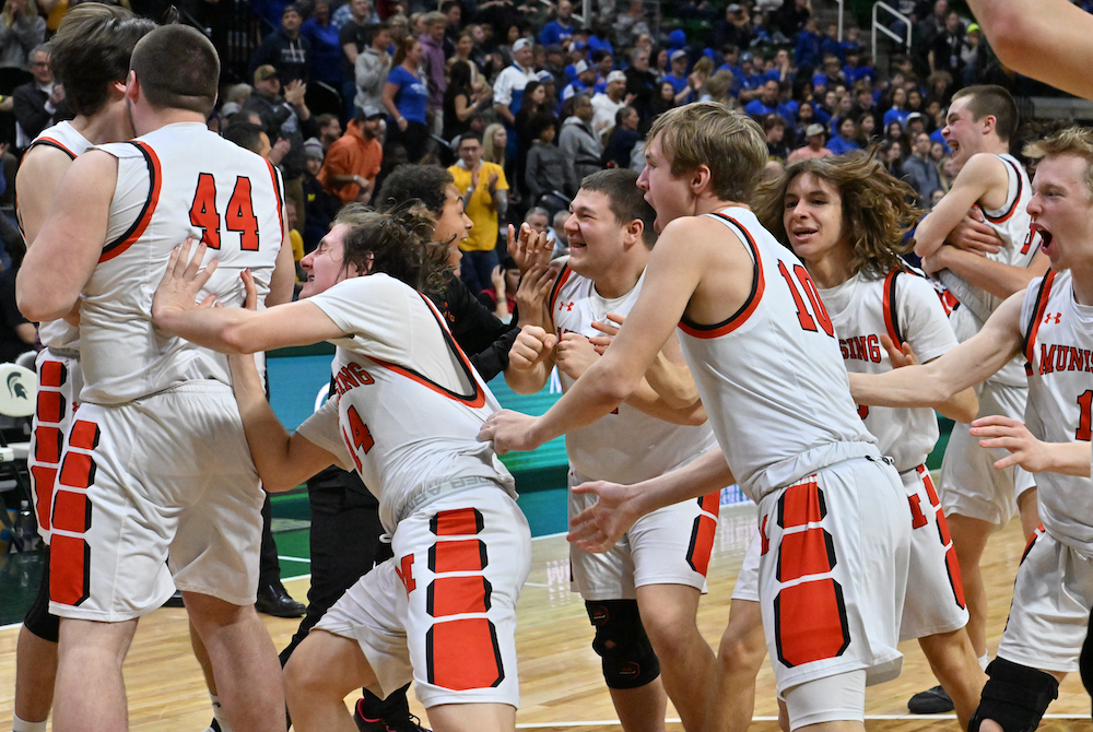Munising players celebrate the team’s first Finals championship Saturday at Breslin Center. 