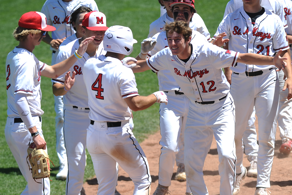 Orchard Lake St. Mary’s Ciaran Caughey (12) welcomes Jake Dresselhouse after the latter scored during last season’s Semifinal win over Grand Rapids Forest Hills Northern.