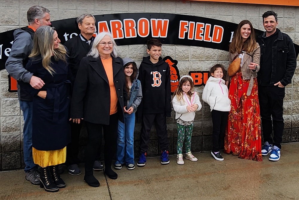 The Carrow family stands together in front of the welcome sign to Carrow Field – including daughter Tiffany (front left), Mark and Mary (second from left, front and back) and son Chris (far right).