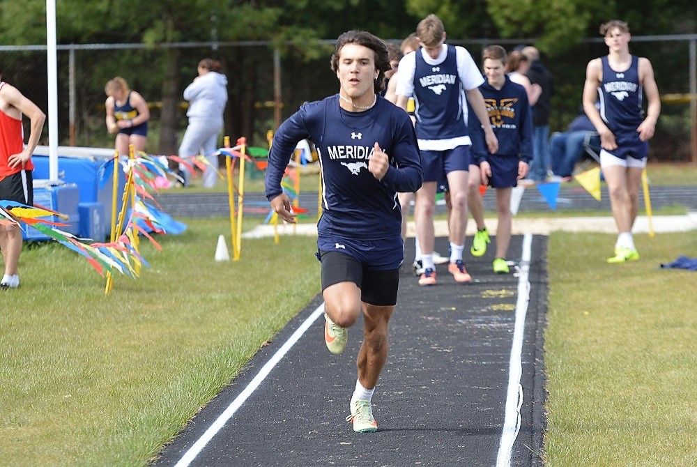 Sanford Meridian’s Brayden Riley makes his approach during the long jump at a home meet May 3 against Beaverton and Shepherd.