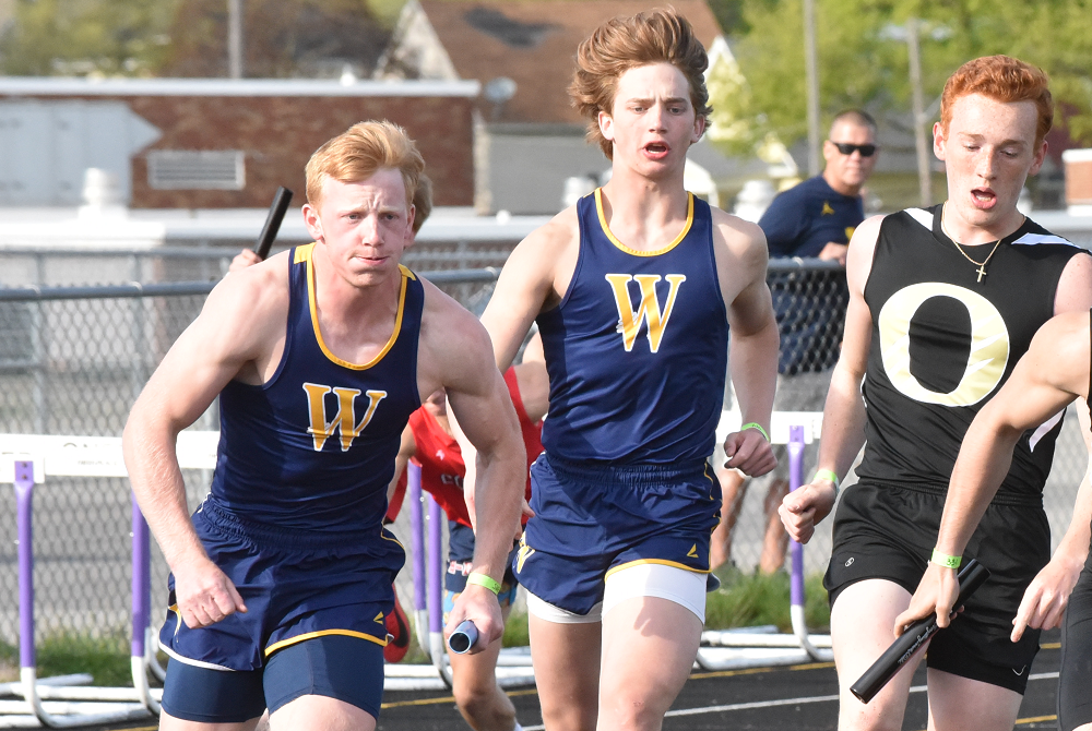 Shea Ruddy (far left) takes the baton from brother Ryin during a relay this season.