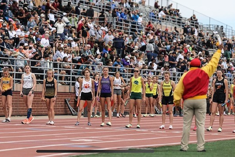 Runners watch official Bertha Smiley as they prepare to begin a race during last season's Lower Peninsula Division 1 Finals at Rockford.