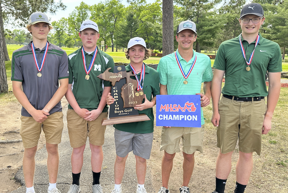 Manistique, including individual medalist Ryan McEvers, celebrate Wednesday’s championship sweep.