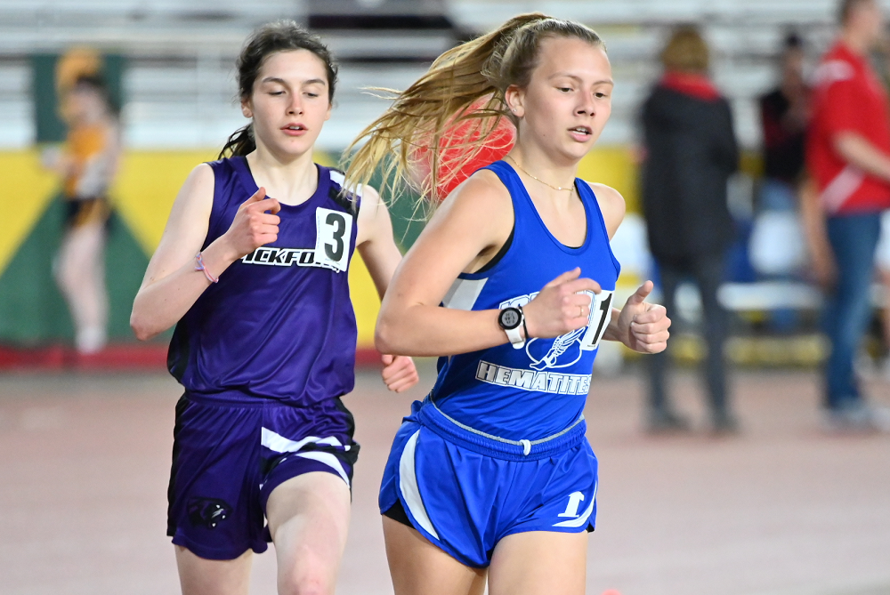Ishpeming's Lola Korpi, right, leads the 800 run during the April 17 Superior Dome Invitational, followed closely by Pickford's Talya Schreiber. 