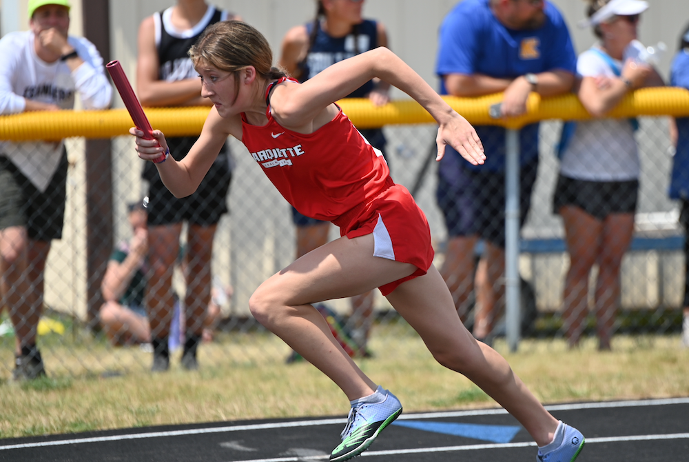 Marquette's Hailey Bolf starts the winning 400 relay Saturday.
