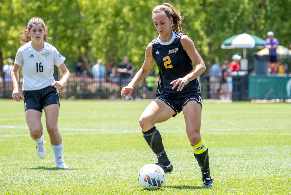 Kalamazoo Christian’s Taylor Leonard (2) controls possession Saturday with Everest Collegiate’s Natalie Cross in pursuit. 