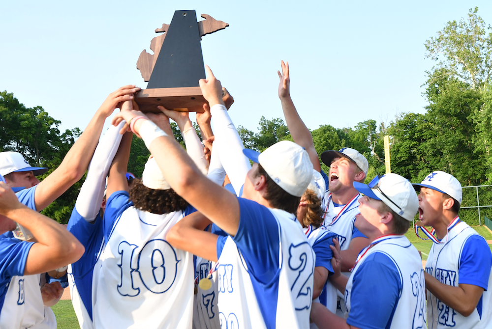 Beal City’s players raise their championship trophy Saturday at McLane Stadium.