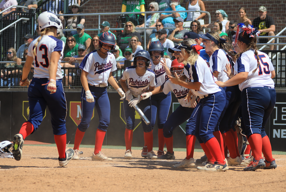 Teammates welcome USA’s Jenna Gremel (13) home during Saturday’s Division 4 Final.