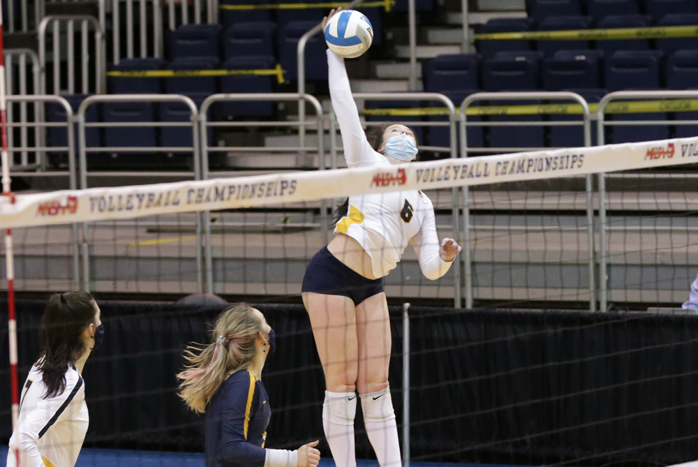 Cadillac's Macy Brown (6) rises above the net during the 2020 Division 2 Semifinals. 