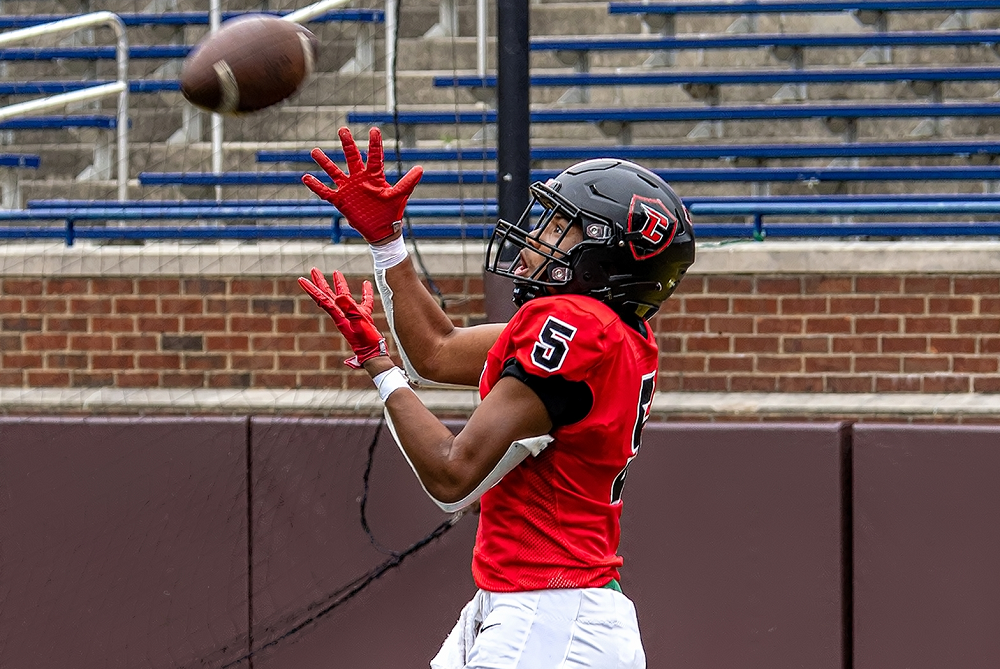A Livonia Churchill player focuses on making the catch during a 2022 game.