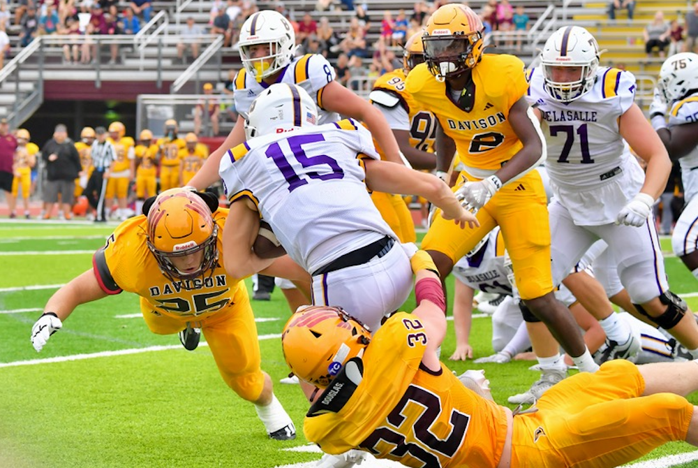 Davison defenders wrap up a Warren De La Salle Collegiate ball carrier during the Cardinals' Week 1 victory. 