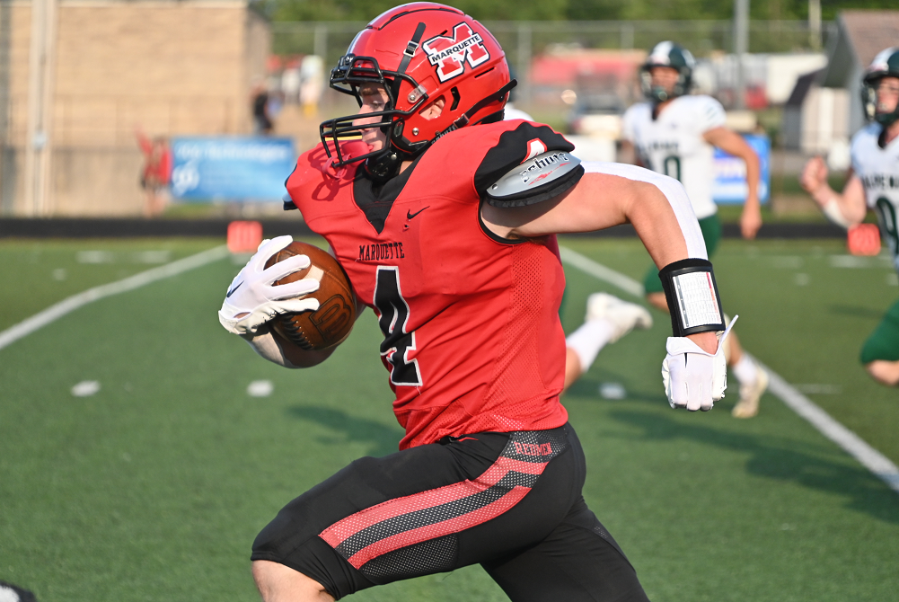 Marquette's Tucker Welch (4) finds a big hole and scores Marquette's first touchdown of its win over Alpena.