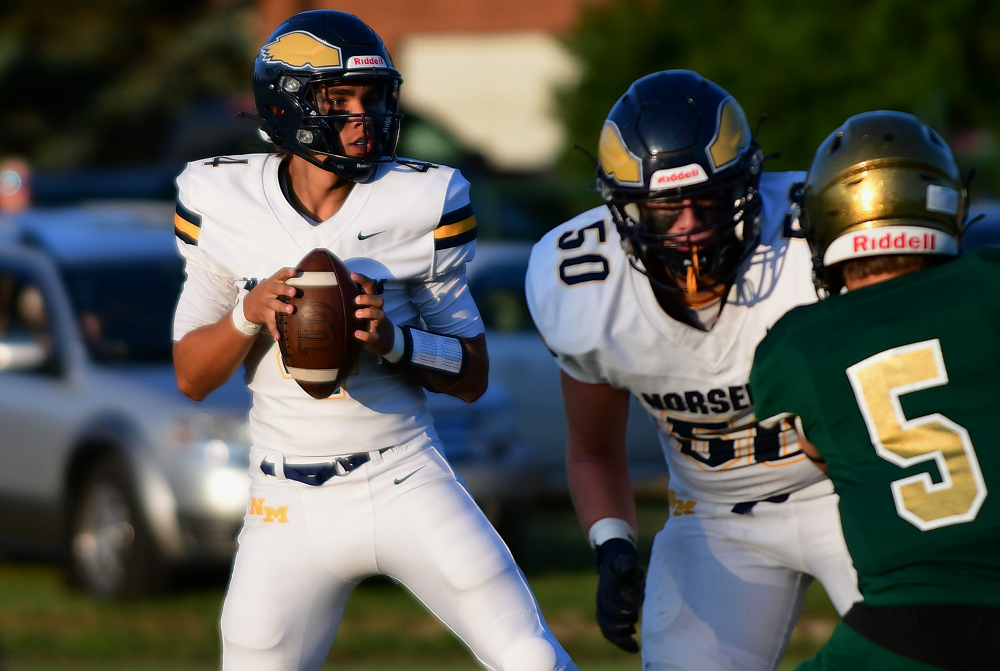 North Muskegon junior quarterback James Young drops back to pass at Muskegon Catholic Central on Aug. 31. Young completed 19-of-20 passes for 390 yards and four touchdowns in the Norsemen's 41-21 victory.