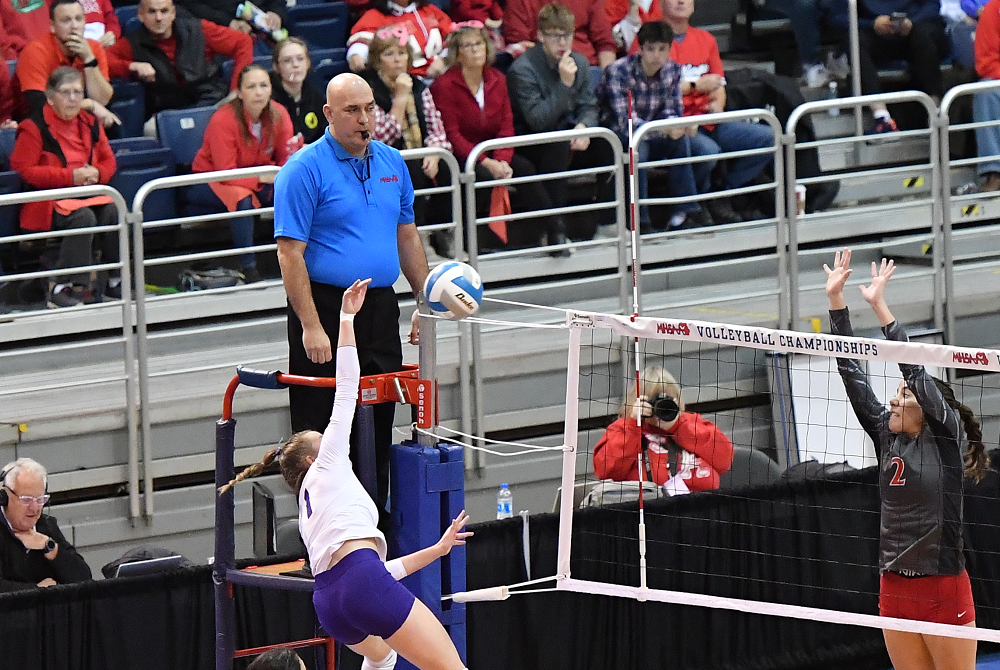 An official monitors the net during the 2022 Division 4 Volleyball Final.