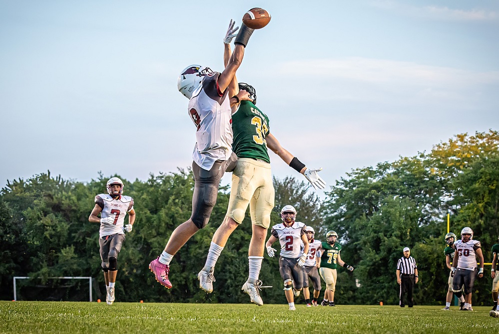 Muskegon Catholic Central and Orchard View players reach to get a hand on the ball during their meeting this season.