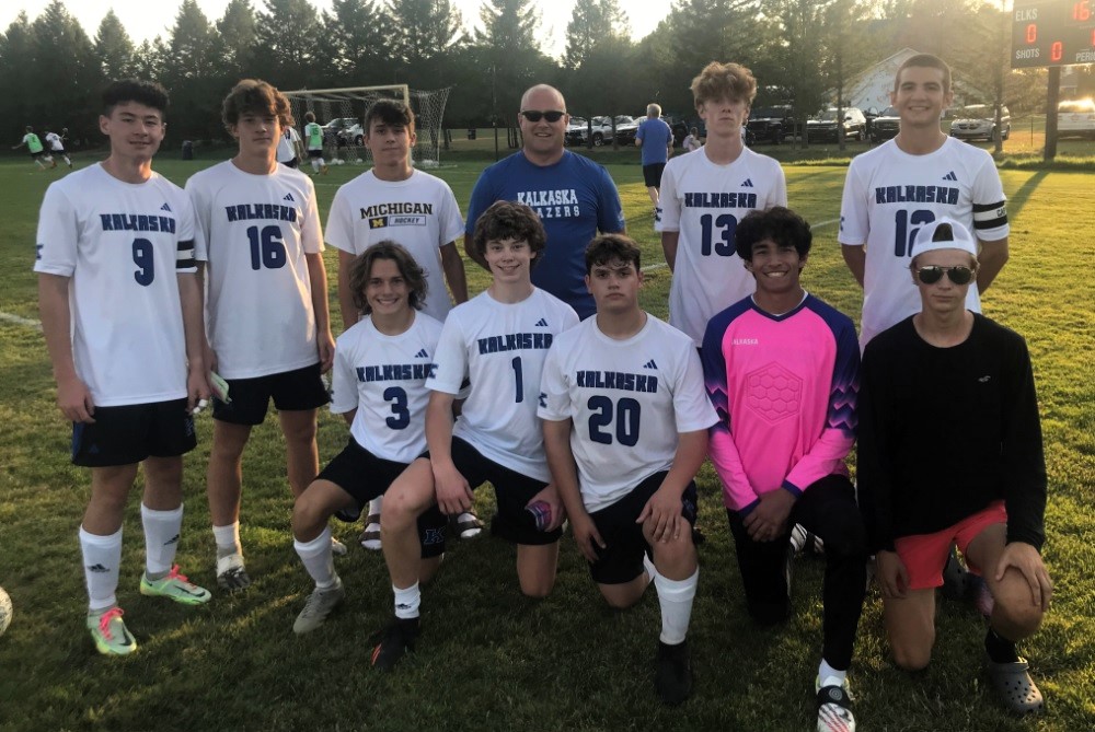 Kalkaska coach David Wagner II stands among his many seniors last week. 