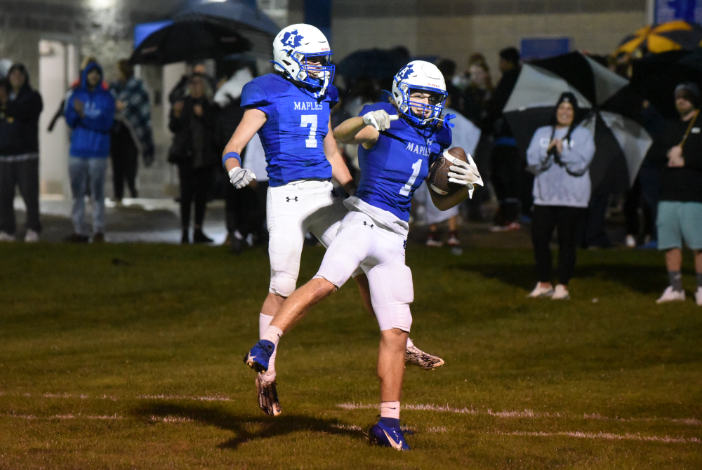 Adrian’s Carson DeKeyser (7) and Thomas Dayharsh celebrate a touchdown during Friday’s 34-0 win over Pinckney.