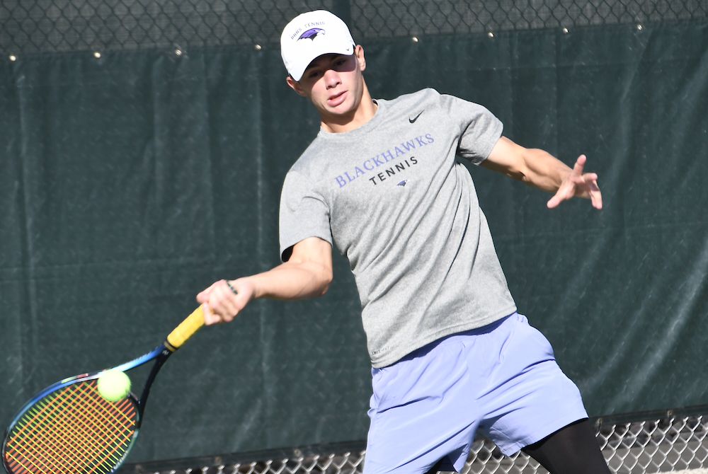 Bloomfield HIlls' Jonah Chernett returns a volley during a No. 1 singles match Saturday at Midland Tennis Center. 