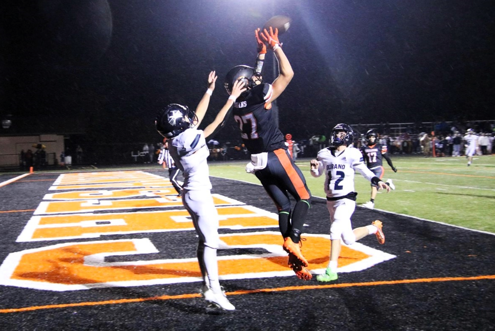Chesaning’s Mason Struck (27) goes high to get his hands on the ball in the end zone during his team’s win over Durand. 